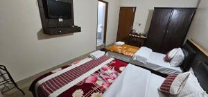Llit o llits en una habitació de Hotel Simara