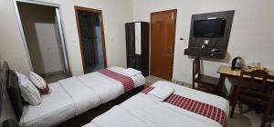 Llit o llits en una habitació de Hotel Simara