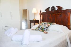 a bedroom with a bed with towels on it at Casa dos Magalhães in Vila do Porto