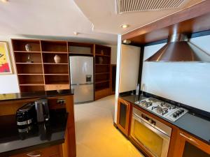 a kitchen with a stove and a refrigerator at Kata Sea View Sanctuary in Kata Beach
