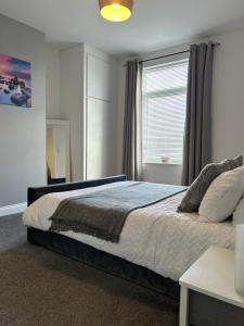 a bedroom with a large bed and a window at Ferrers House in Doncaster