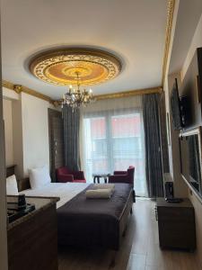 a hotel room with a bed and a chandelier at Borancik hotel in Istanbul