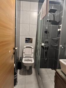 a small bathroom with a toilet and a sink at Borancik hotel in Istanbul