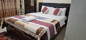 Llit o llits en una habitació de Hotel Simara