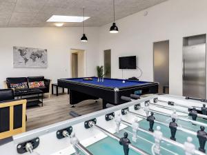 a billiard room with a pool table and a couch at 16 person holiday home in V ggerl se in Marielyst