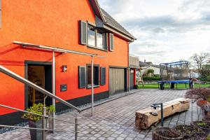 an orange building with a playground next to a house at Ferienhaus Sieger in Salem