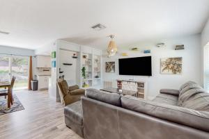 a living room with couches and a flat screen tv at BayCation in Tampa