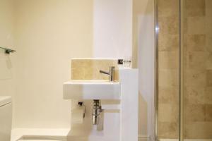 a bathroom with a sink and a shower at Noa Residence in Oxford