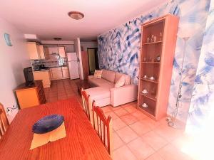 a living room with a table and a couch at Corralejo Del Mar in Corralejo