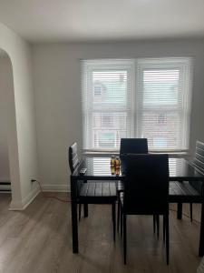 a dining room with a table and chairs and two windows at Town Inn in Prescott