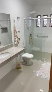 a bathroom with a glass shower and a toilet at Casa próximo do aeroporto de Brasília in Brasilia