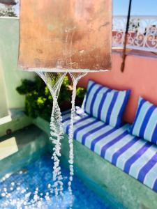 a water fountain in a room with a couch at Riad 11 Zitoune in Marrakesh