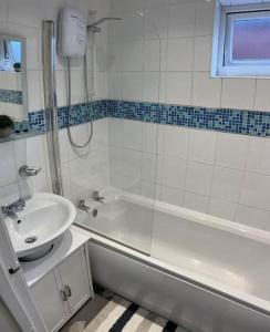a white bathroom with a sink and a tub and a sink at Stockton House in Stockton-on-Tees