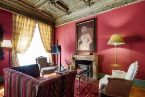 a living room with red walls and a fireplace at M Maison Particulière Porto in Porto