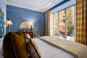 1 dormitorio con 1 cama con pared azul en M Maison Particulière Porto en Oporto
