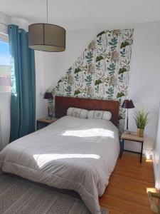 a bedroom with a large bed with a headboard at Sangatte Guest House - Studio Room - le Sunset - Seafront in Sangatte
