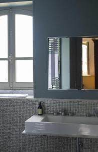 a bathroom with a sink and a mirror at Les Tilleuls Etretat in Étretat