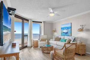 a living room with a couch and a view of the ocean at Phoenix 6 Unit 706 in Orange Beach