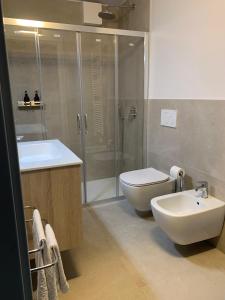 a bathroom with a toilet and a sink and a shower at Panorama Loft Apartments in Stresa