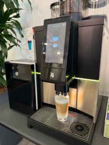 uma cafeteira com uma chávena de café em Fair´n Square Hotel 24 Stunden Check In em Darmstadt