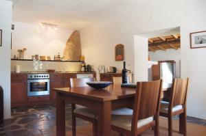 a kitchen with a wooden table and a dining room at Quinta da Saimeira in Marvão