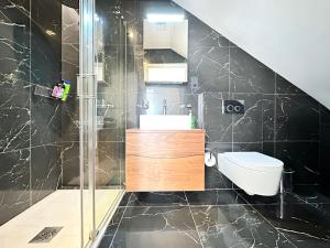 La salle de bains est pourvue d'une douche, d'un lavabo et de toilettes. dans l'établissement Chic apartment in Queensway for six guests, à Londres