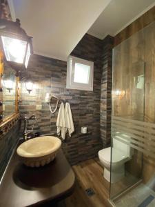a bathroom with a sink and a toilet at Teo & Niki in Paleokastritsa