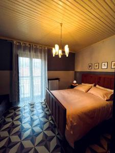 a bedroom with a large bed and a window at Bed and breakfast da Peppino in Bianchi