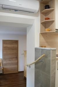 a kitchen with a stone counter and a wooden door at Apartment Pr'pek in Bohinj