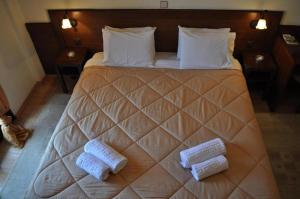 a bedroom with a large bed with two towels on it at Philoxenia in Kavála