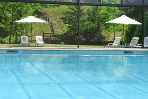 a group of chairs and umbrellas next to a swimming pool at RVHotels Tuca in Vielha