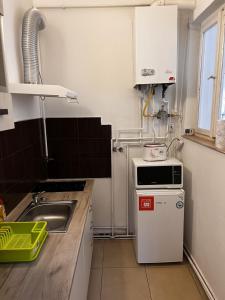 a small kitchen with a sink and a stove at Apartament 13 Central in Târgu-Mureş