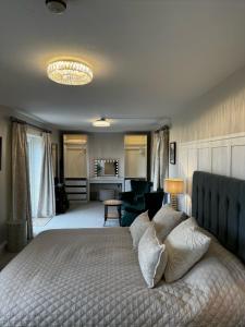 a bedroom with a large bed and a living room at Chequers Inn in Harrogate