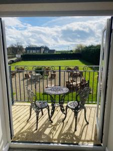 a view of a balcony with a table and chairs at Chequers Inn in Harrogate