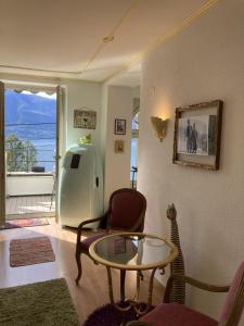 ein Wohnzimmer mit einem Tisch und ein Zimmer mit Aussicht in der Unterkunft BnB122 bed&breakfast in Ascona