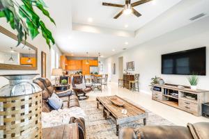 a living room with a couch and a tv at Tampa Home with Fire Pit, Grill, Cornhole and More! in Tampa