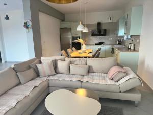 a living room with a couch and a table at VILLA ANDERR in Sarandë