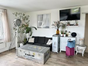 a living room with a couch and a flat screen tv at Vista Suites 1-2 in Budapest