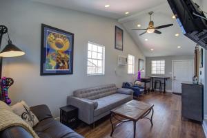 a living room with a couch and a table at Charming Conti Nest with Large Courtyard in New Orleans