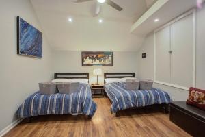 a bedroom with two beds and a couch at Charming Conti Nest with Large Courtyard in New Orleans