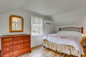 a bedroom with a bed and a dresser and a mirror at Historic Farmhouse in Layton with Deck! in Layton