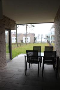 two chairs and a table on a patio with a view at Nautica Bliss in Giżycko