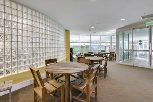 a dining room with tables and chairs and windows at Caribe Resort Unit C814 in Orange Beach