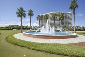 a fountain with palm trees in front of a building at Caribe Resort Unit C814 in Orange Beach