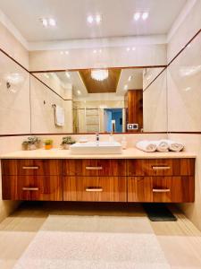 La salle de bains est pourvue d'un lavabo et d'un grand miroir. dans l'établissement MICKA 25, à Skarżysko-Kamienna