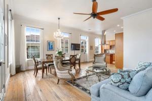 a living room with a blue couch and a table at The Burgundy House #1 Steps to the French Quarter in New Orleans