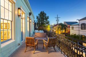 a patio with two chairs and a table on a balcony at The Burgundy House #1 Steps to the French Quarter in New Orleans