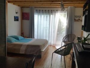 a bedroom with a bed and a large window at Les Flots Bleus in Andernos-les-Bains