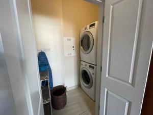 a laundry room with a washing machine and a washer at The Burgundy House #2 steps to the French Quarter in New Orleans