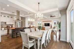 a kitchen and dining room with a table and chairs at The Burgundy Penthouse Steps to the French Quarter in New Orleans